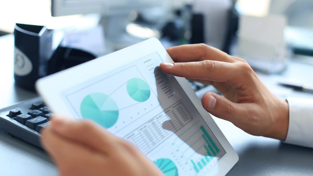 Businessman Holding Tablet with Data Dashboard