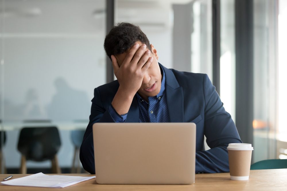 Businessman upset on laptop