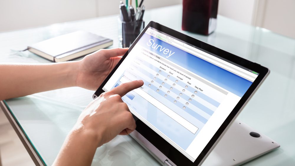 Customer fills out online satisfaction survey on tablet