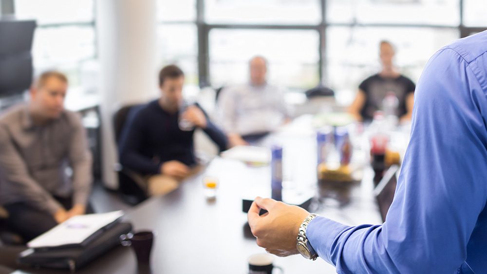 Businessman talking to office team about training