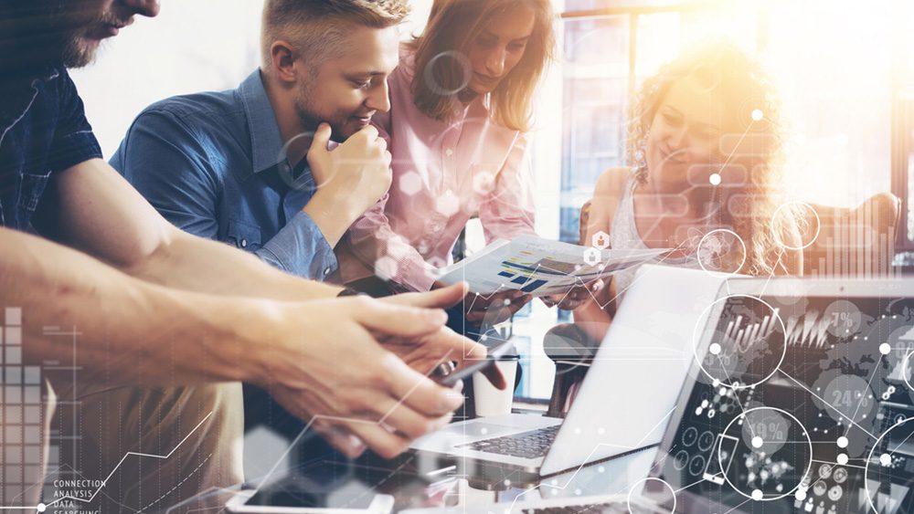 Young team of innovative data analysts look at member graphs