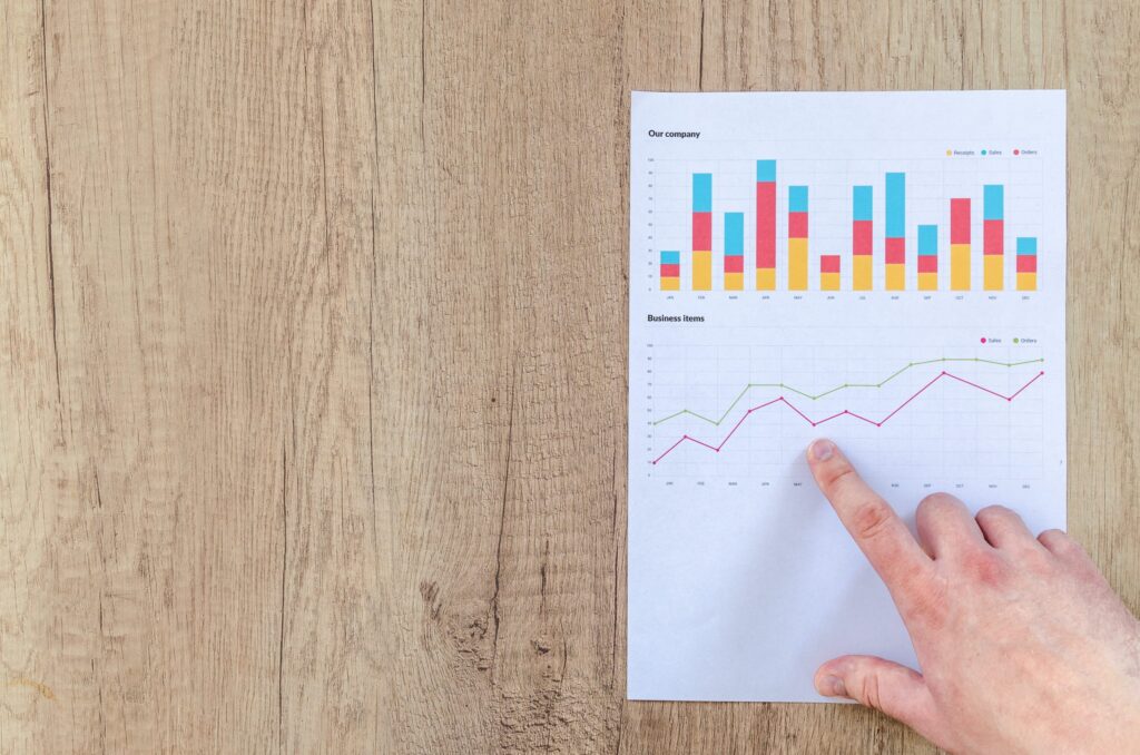 Man points at business benchmark trend charts